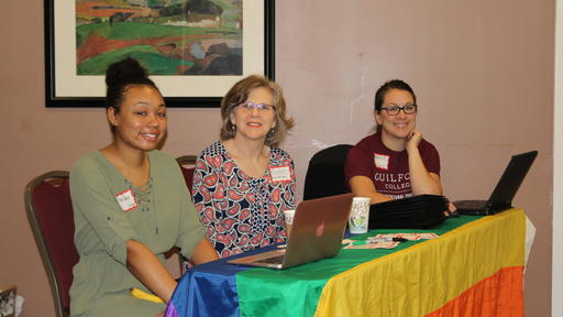 Staff sit at the sign-in table at the Bayard Rustin Symposium.