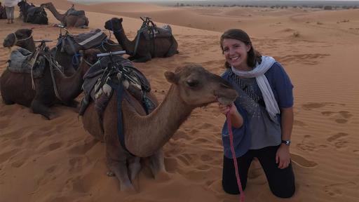 Katie Claggett takes a photo with camels in Morocco.