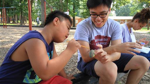 Bonner scholars paint with children at Glen Haven on Day of Service.