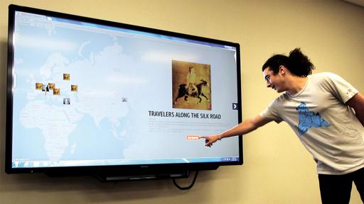 A student discusses the Silk Road presentation web project in the Collaboratory in Hege Library.
