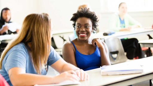 Guilford College students chat in class.