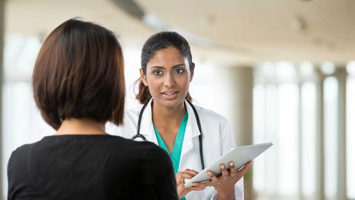 Photo of a patient speaking with a woman doctor.