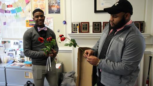 Members of Brothers Doing Positive pass out roses.