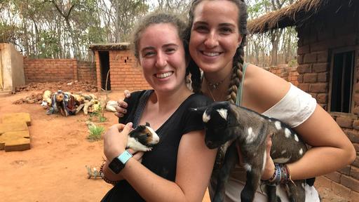 Student Mallory Cerkleski and a friend hold goats in this photo from their study abroad trip.