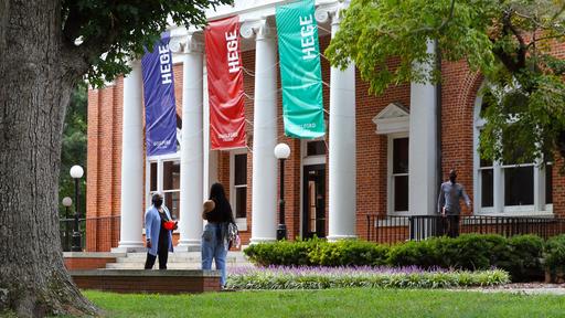 Students, faculty, and staff walk in front of Hege Library.