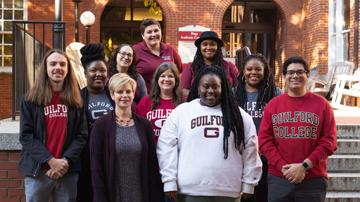 The Guilford College Guided Discovery Team stands on the steps of the library.