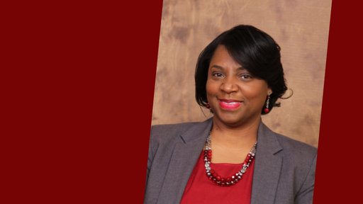 Erickia Elbert, wearing a red shirt, gray jacket, and beaded necklace