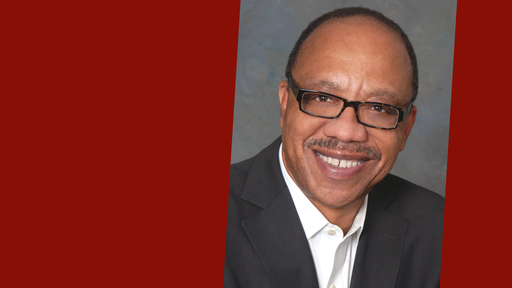 Eugene Robinson, wearing glasses, a gray blazer, and a white shirt