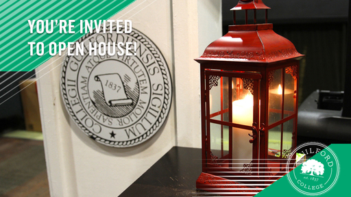 A red lantern with a lit candle inside of it sits next to a podium showing the Guilford College seal.