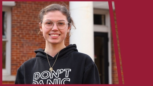 Breanna Barham '22 stands outdoors on Guilford campus, wearing a black sweatshirt and glasses.