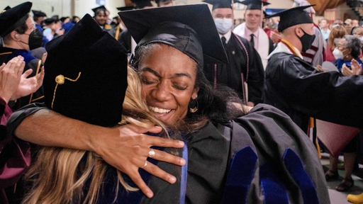 An honors student hugging Heather Hayton after Commencement.