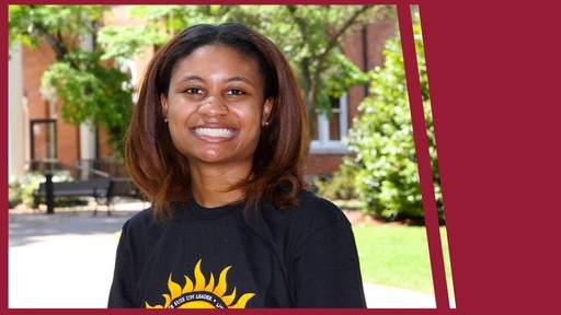 Erin Askew stands outdoors wearing a black t-shirt with a sun graphic on the front.