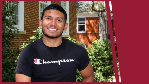 Jonathan Nunez '22 stands outdoors on Guilford's campus wearing a black t-shirt with a white Champion logo across the chest.