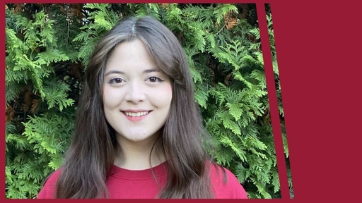 Liz Dizon stands outdoors wearing a red t-shirt.