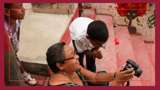Guilford Professor Maria Amado shows off her photography skills to Panamanian children.