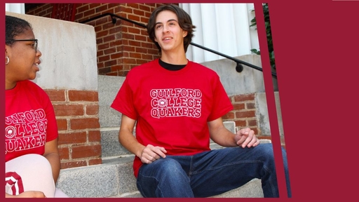 Griffin Icenhour sits on the steps of New Garden Hall, wearing a red Guilford College Quakers t-shirt and chatting with another student.
