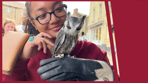 H'neamy Mlo '23 holds an owl over a gloved hand during a study-abroad trip to Scotland.