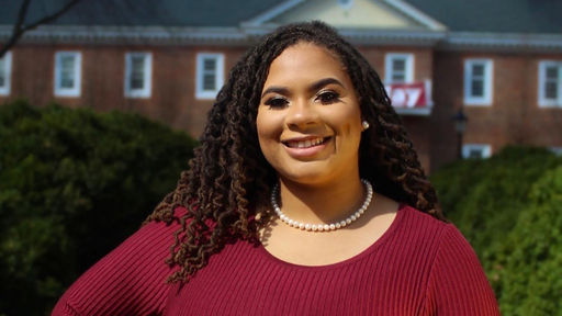 Kennedy Ruff in front of Founders Hall wearing a burgundy sweater