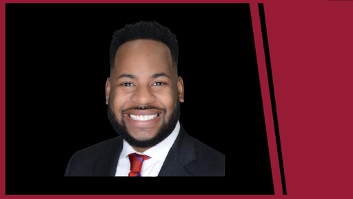 Jerell Blakeley in a dark suit and red tie