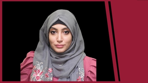 Hourie Tafech in a pink blouse and grey head scarf