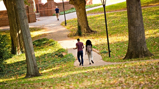 Students walk across the Quad toward Founders Hall.