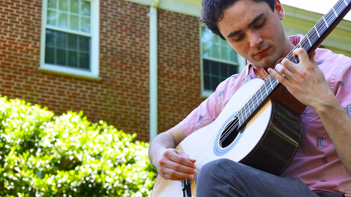 Emmett Edwards '23 plays guitar in the Guilford College Quad