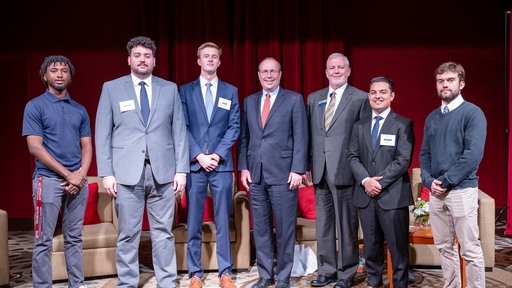 Guilford College students on stage at a business summit in 2023