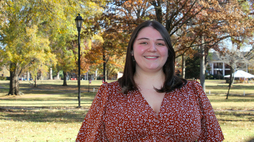 Kristen Hooks on the Quad in the fall, wearing a floral print dress