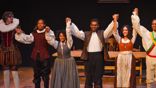 revelers in costume in a stage production in Sternberg Auditorium