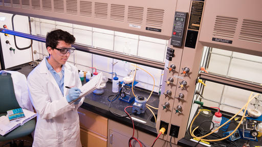 A student works an experiment in a lab.