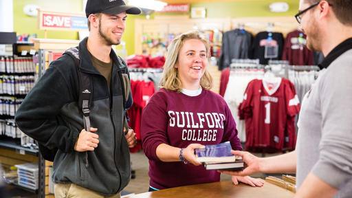 Students make a purchase at the College Bookstore.