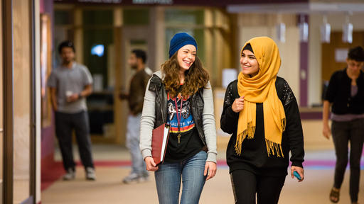 Students walk and chat in Hege Library.