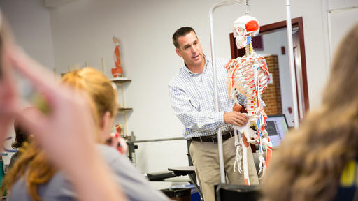 Professor Carig Eilbacher teaches with a skeleton in a Sport Studies class.