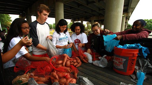 Guilford Bonner volunteers share yams at the Church Under the Bridge.
