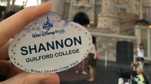 Shannon holds her namebadge at Disney World.