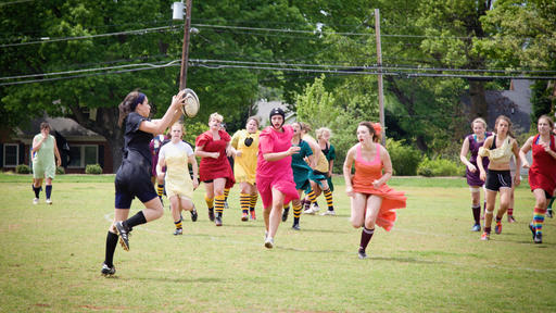 Students play women's rugby.