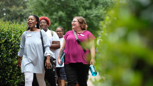 Students and staff walk in the Quad.