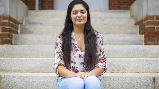 Guilford College student Chelsea Sosa-Sosa sits on the steps of New Garden Hall