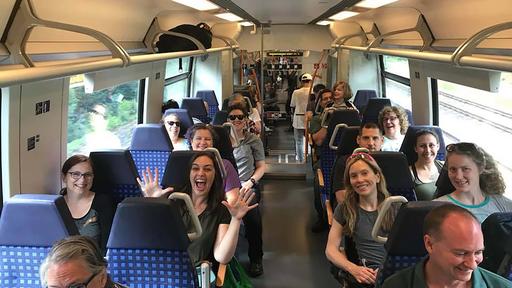 Faculty, staff, and students ride a bus in Germany.