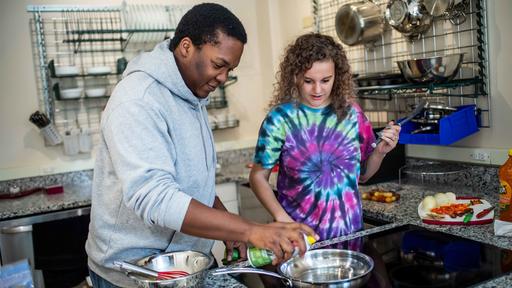 Students cook together in the fully stocked kitchen in Binford Hall.
