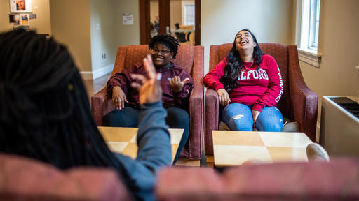 Students hang out together and laugh upstairs in Founders Hall.