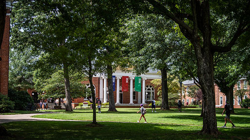 Student walk across campus in front of Hege Library.