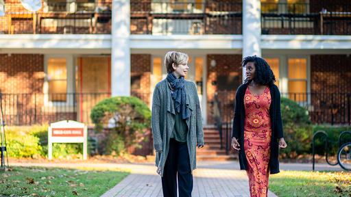 Professor of Art Kathryn Shields and Janey Rich '23 walk in front of Hege-Cox Hall.