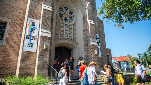 Students walk into a church for a meeting about social justice.