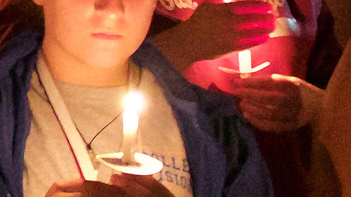 A student holds a candle during the annual Passing of the Light. Photo by Ava Nadel.